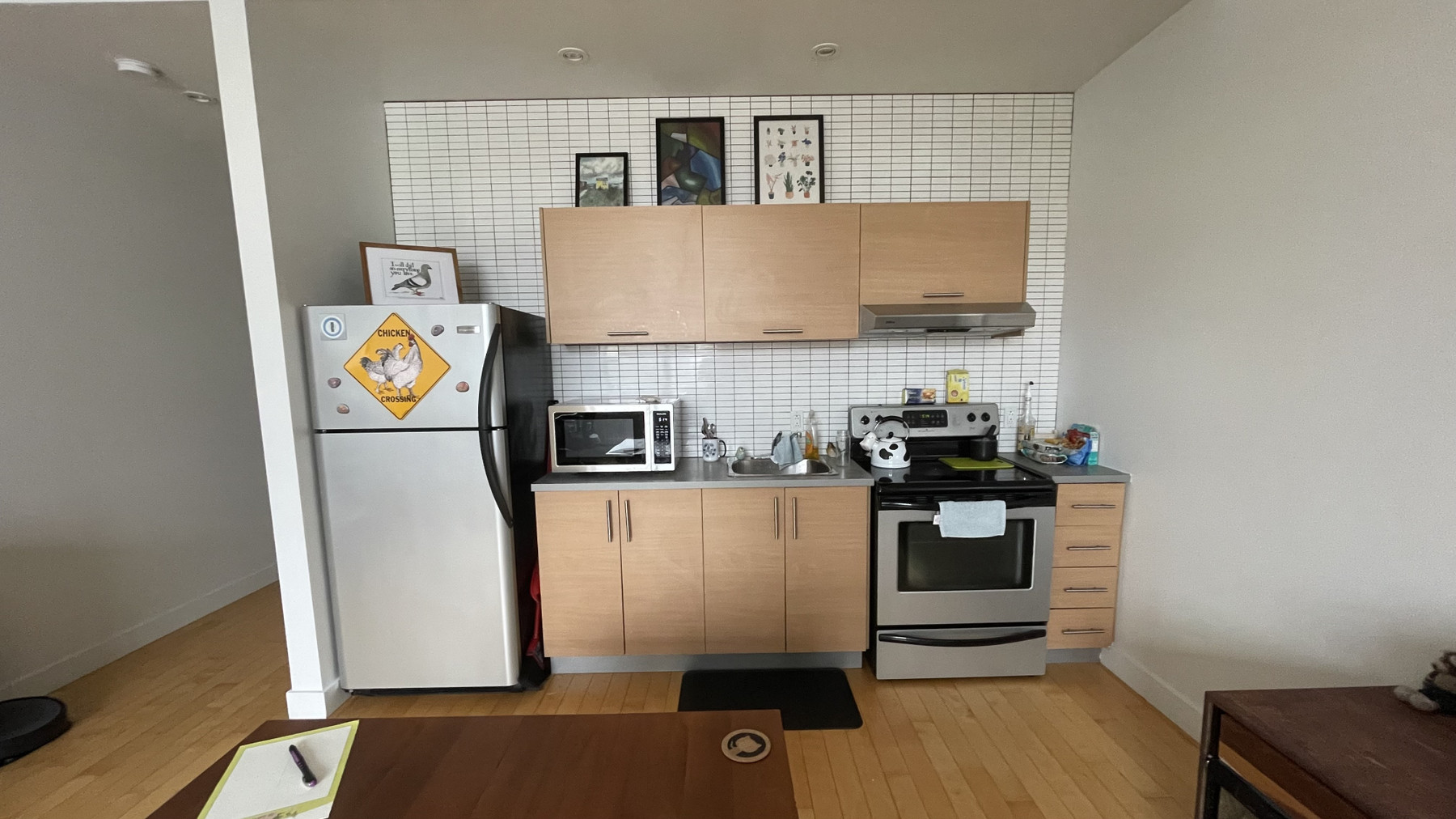 An image with caption: Wide shot of my studio’s kitchen.